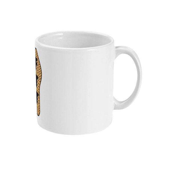 An 11oz ceramic mug with a glossy white finish featuring a brown and black design of a trainer sole.