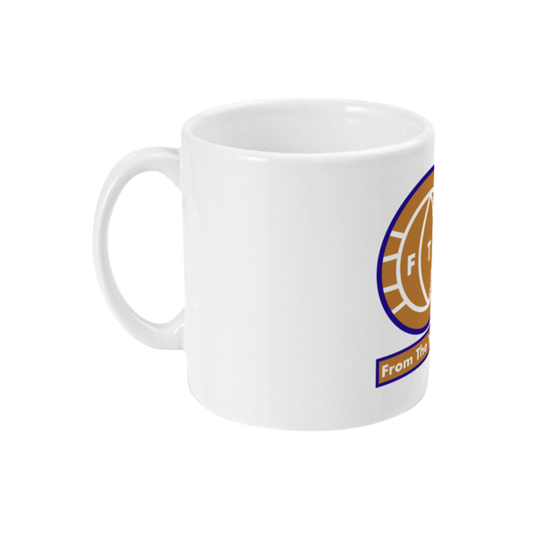 A white ceramic mug with a colorful graphic of a cartoon football character and the text 'FTT' on the front.