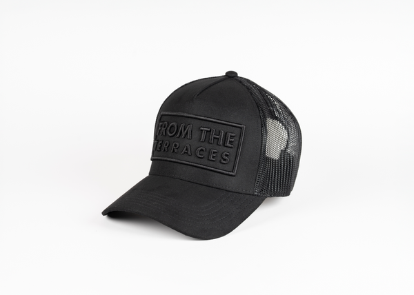 Black trucker cap with mesh back on a white background