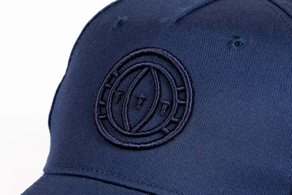 Navy blue cap with a logo on a white background
