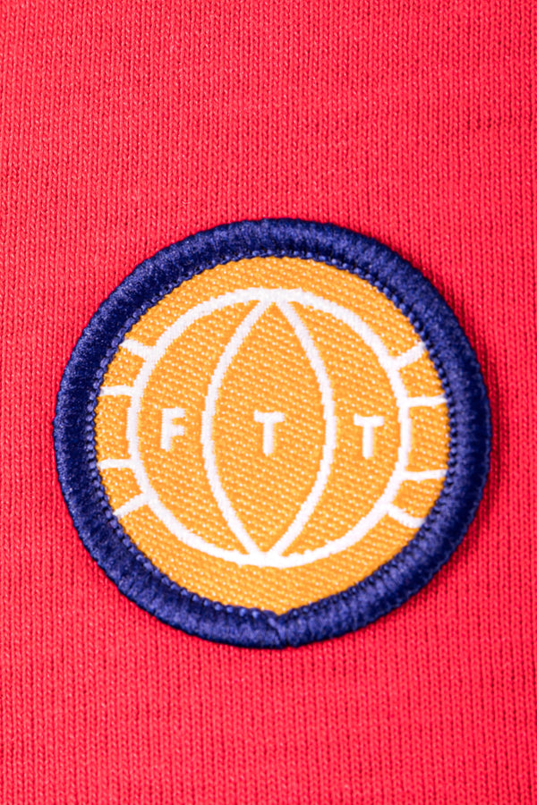 Patch with 'FTT' logo on a red background