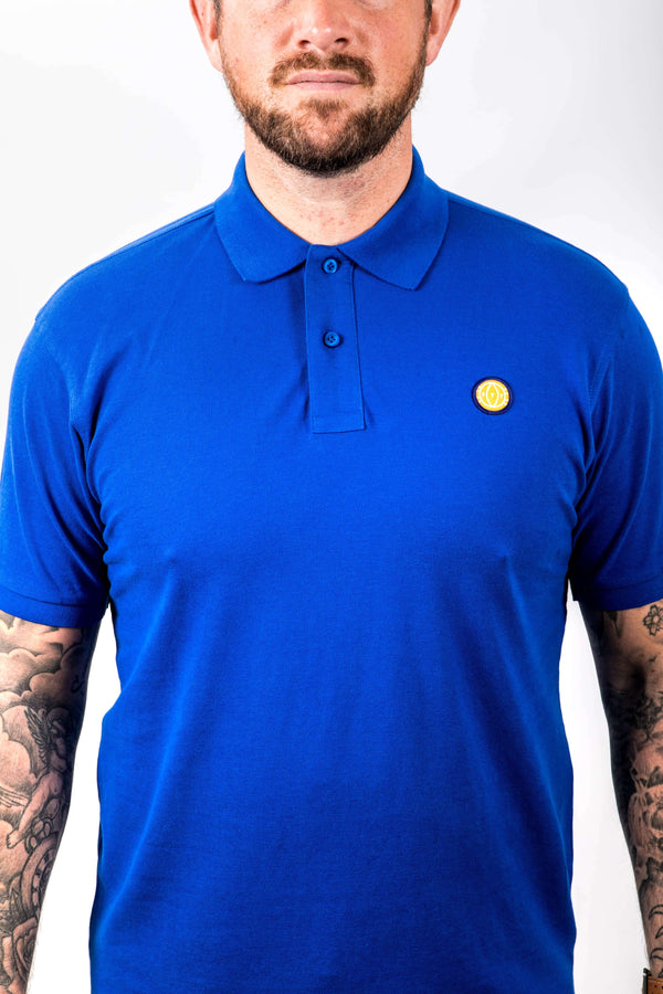 Man wearing a blue polo shirt with a yellow logo on a white background