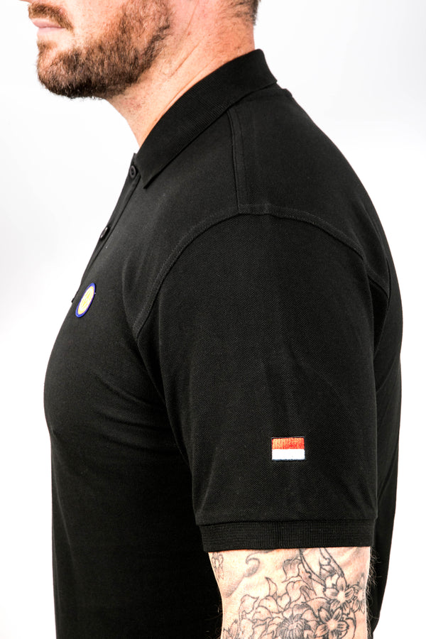 Black polo shirt with small flags on sleeves worn by a person