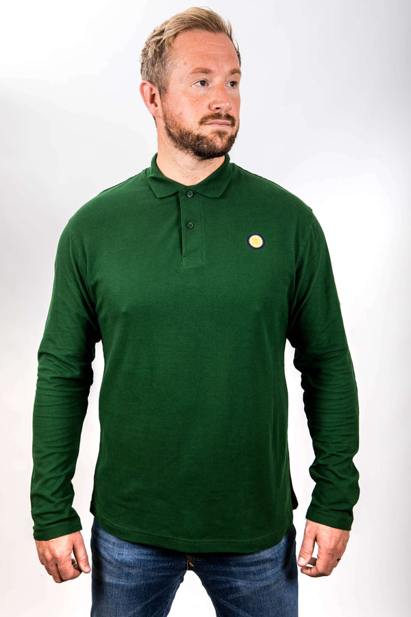 Man wearing a green long-sleeve polo shirt with a small logo on a white background