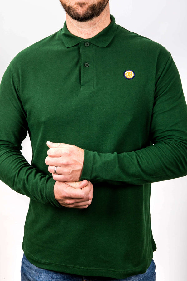 Person wearing a green long-sleeve polo shirt with a small yellow logo on a white background