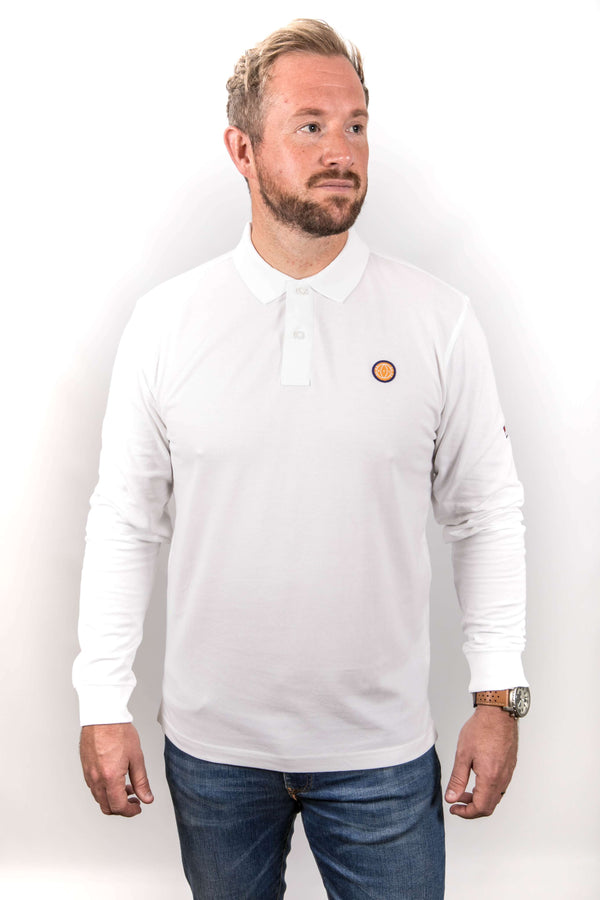 Man wearing a white long-sleeve shirt with a logo on a plain background