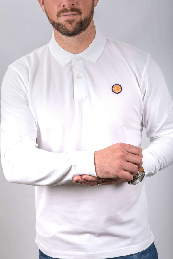 Person wearing a white long-sleeve polo shirt with a small logo on a plain background