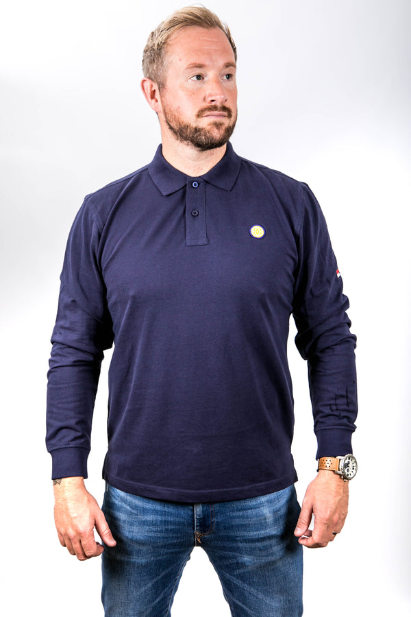 Man wearing a navy long-sleeve polo shirt with a small logo on a white background