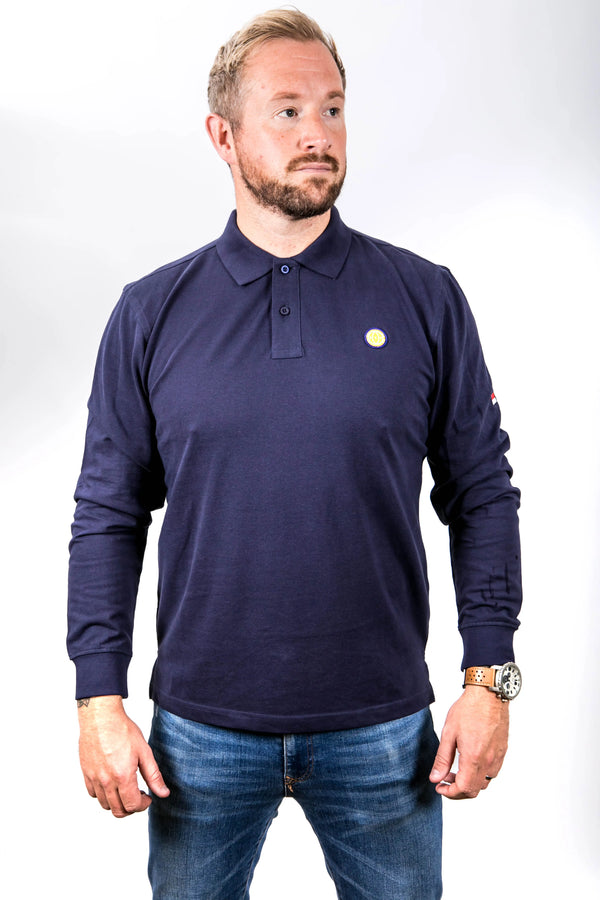 Man wearing a navy long-sleeve polo shirt with a small logo on a white background