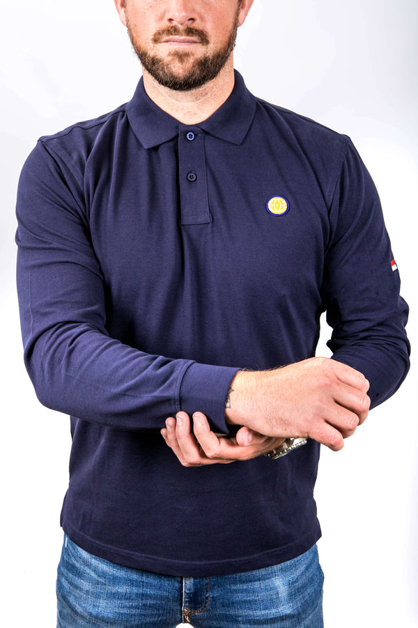 Man wearing a navy long-sleeve polo shirt with a small yellow logo on a white background