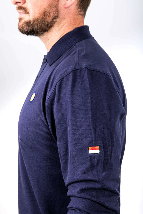Navy long-sleeve shirt with small flags on sleeves worn by a person against a plain background