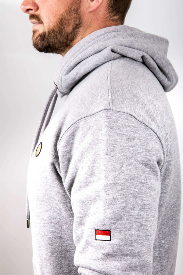 Gray hoodie with small flags on a plain background