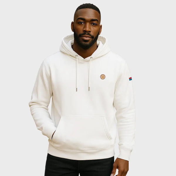 Man wearing a white hoodie with brand logos on a light gray background