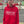 Person wearing a red hoodie with 'From the Terraces' text in an urban setting