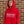 Person wearing a red hoodie with 'FROM THE TERRACES' text against a brick wall.