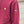 Maroon hoodie with a logo on the chest and another on the sleeve, outdoors.
